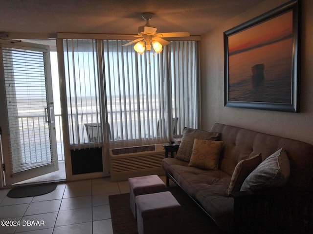 tiled living room featuring a wall mounted AC and ceiling fan