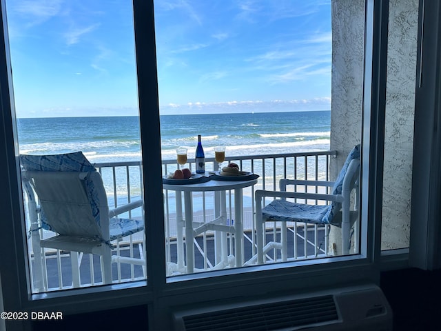 balcony featuring a water view and a beach view