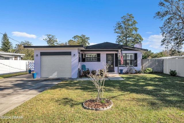 ranch-style home with a garage and a front lawn