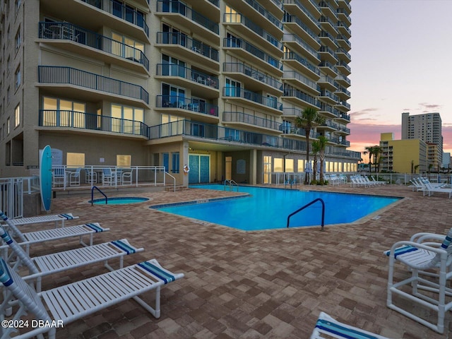 pool at dusk with a patio