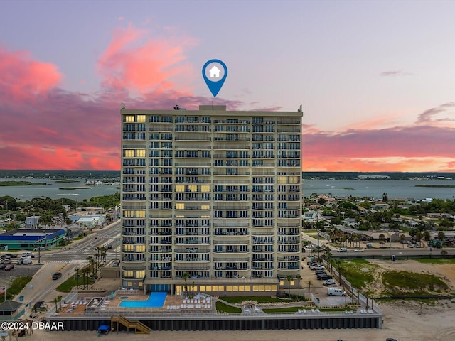 outdoor building at dusk featuring a water view