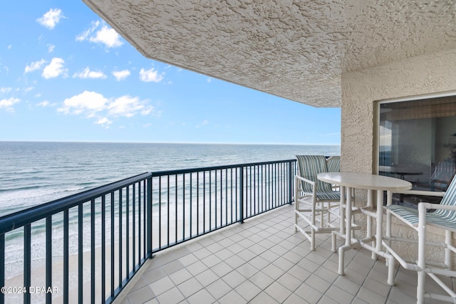 balcony with a beach view and a water view