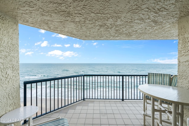 balcony with a view of the beach and a water view