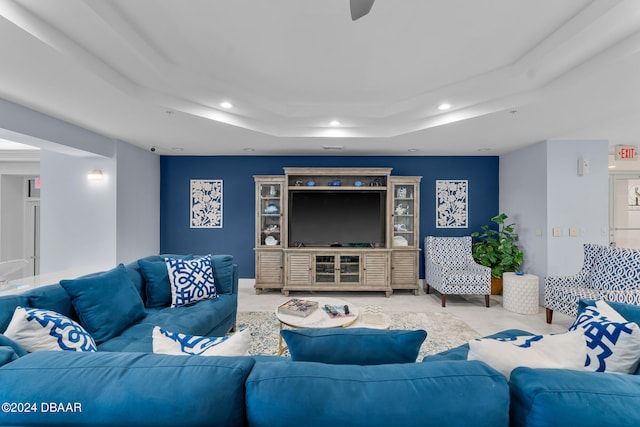 carpeted living room featuring a tray ceiling