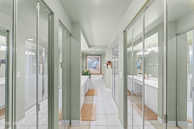 3425 S Atlantic Ave Unit 1105, Daytona Beach Shores, FL 32118 - bathroom with a garden tub, tile patterned flooring, a stall shower, and vanity