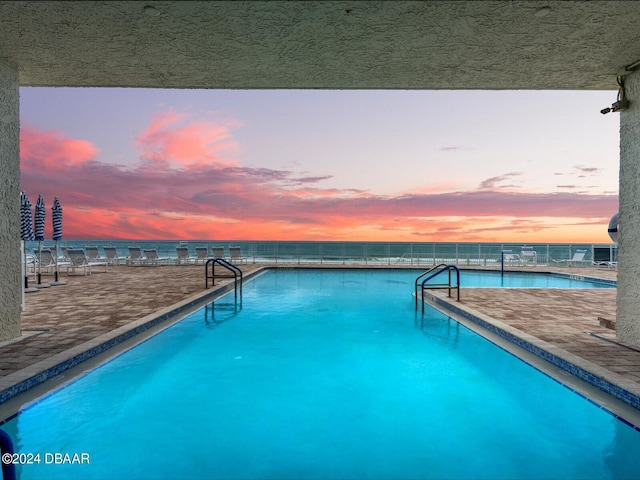 view of pool at dusk