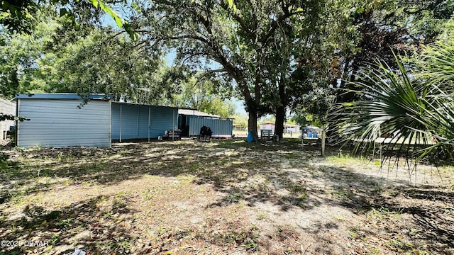 1228 Leon Ln, Daytona Beach, FL 32117 - view of yard featuring an outdoor structure and an outbuilding