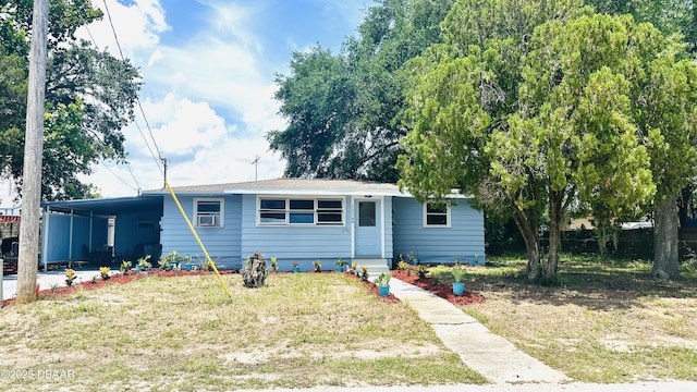 1228 Leon Ln, Daytona Beach, FL 32117 - view of front facade featuring a carport and a front lawn
