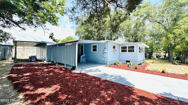 1228 Leon Ln, Daytona Beach, FL 32117 - view of front of home with concrete driveway and a carport