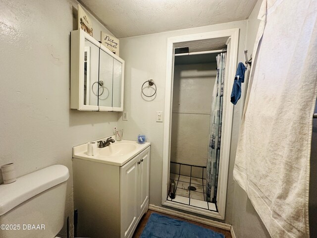1228 Leon Ln, Daytona Beach, FL 32117 - bathroom featuring vanity, a textured ceiling, a shower stall, and toilet