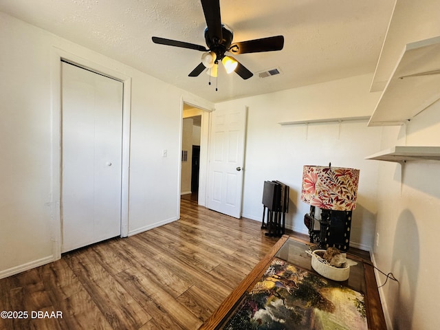 1228 Leon Ln, Daytona Beach, FL 32117 - home office with wood finished floors, a ceiling fan, baseboards, and a textured ceiling