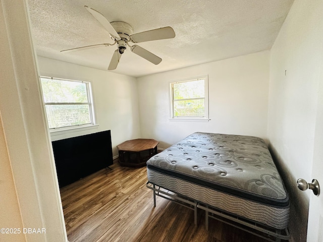 1228 Leon Ln, Daytona Beach, FL 32117 - bedroom featuring wood finished floors, a ceiling fan, and a textured ceiling