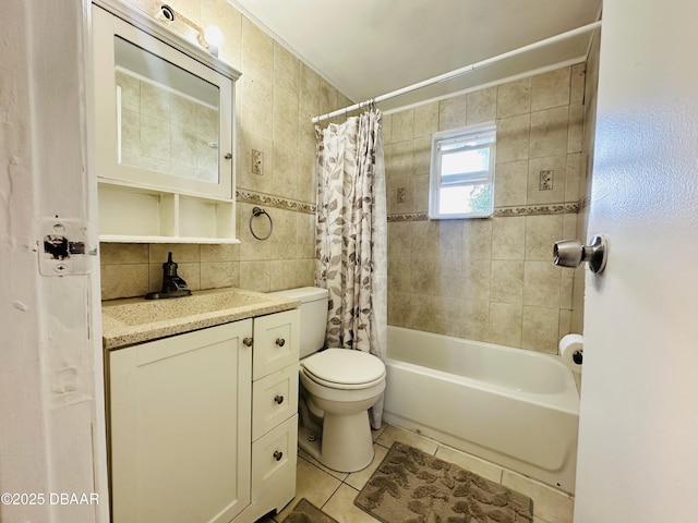 1228 Leon Ln, Daytona Beach, FL 32117 - full bath featuring tile patterned floors, toilet, vanity, tile walls, and shower / bath combination with curtain