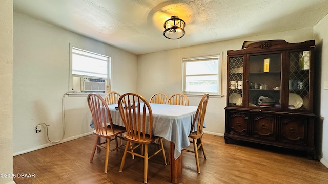 1228 Leon Ln, Daytona Beach, FL 32117 - dining area with wood finished floors, cooling unit, and baseboards