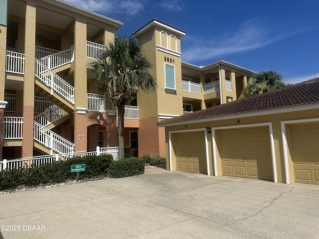 3651 S Central Ave Unit 101, Flagler Beach, FL 32136 - view of apartment building / complex featuring community garages and stairway