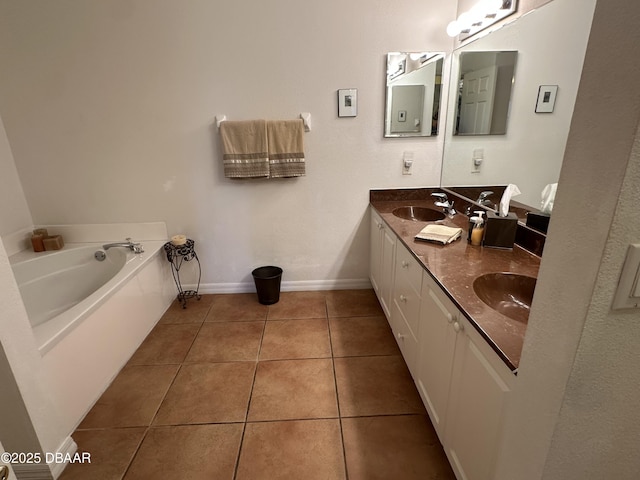 3651 S Central Ave Unit 101, Flagler Beach, FL 32136 - full bath featuring double vanity, tile patterned floors, baseboards, and a garden tub