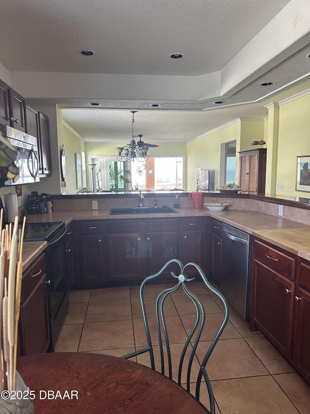 3651 S Central Ave Unit 101, Flagler Beach, FL 32136 - kitchen featuring stainless steel appliances, a sink, light tile patterned flooring, recessed lighting, and dark brown cabinets