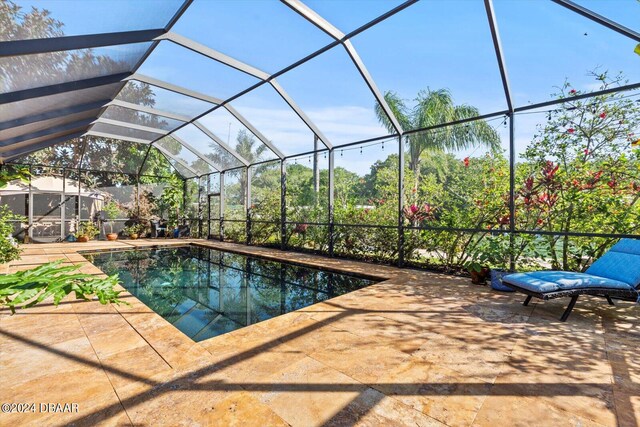 view of pool featuring a lanai and a patio area