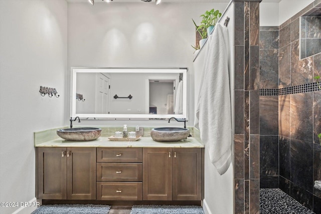 bathroom featuring vanity and a tile shower