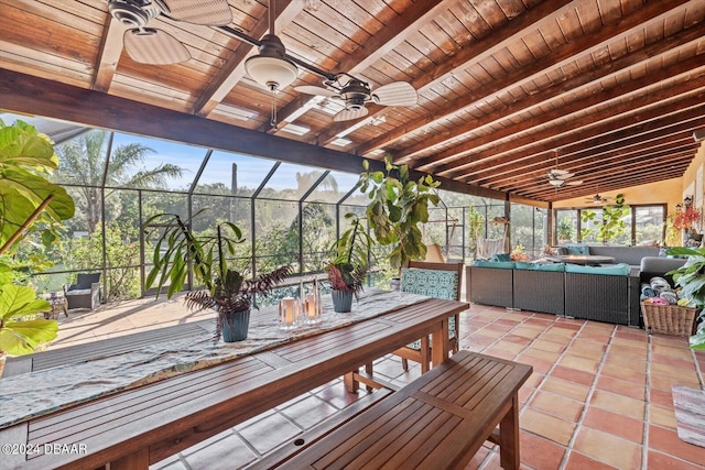 unfurnished sunroom featuring ceiling fan, wood ceiling, and lofted ceiling with beams