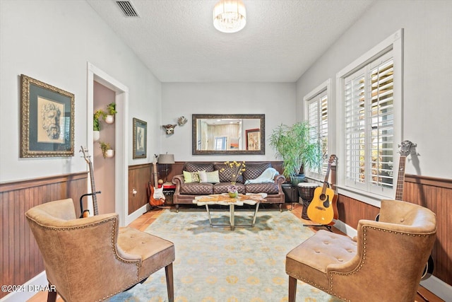 interior space featuring wood walls and a textured ceiling