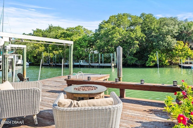 view of dock featuring a water view and an outdoor fire pit