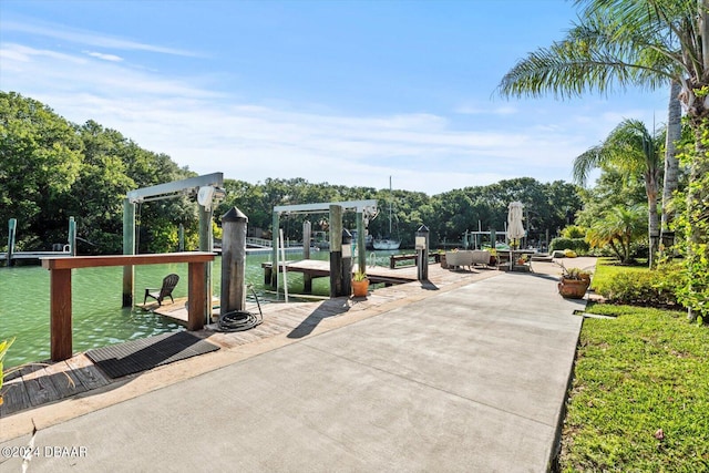 view of community featuring a water view and a dock