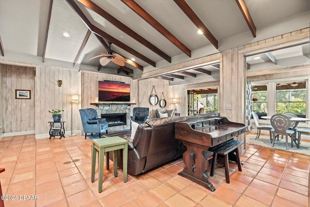 living room with light tile patterned flooring, ceiling fan, and wooden walls