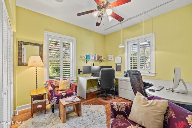 home office with hardwood / wood-style flooring and ceiling fan