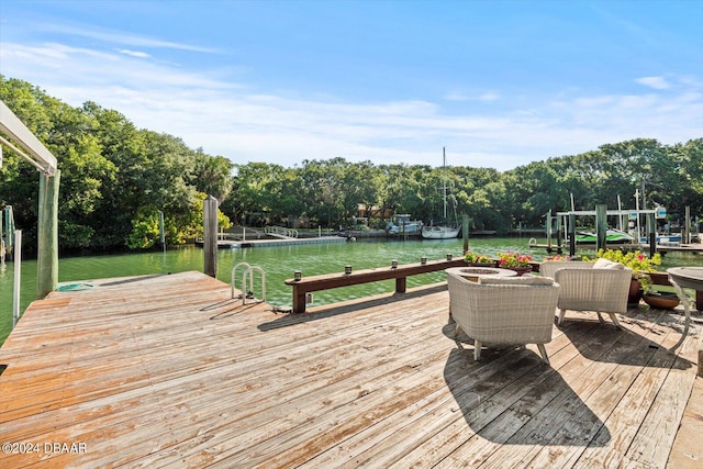 deck with a water view and a dock