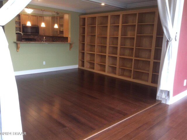 interior space with ornamental molding and dark hardwood / wood-style floors