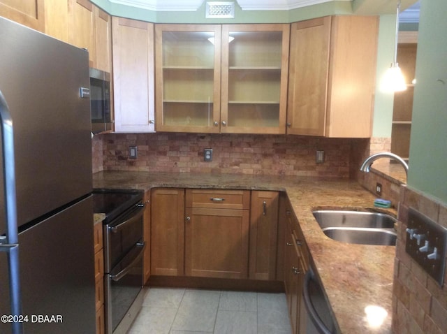 kitchen featuring stainless steel appliances, sink, light stone countertops, light tile patterned floors, and decorative backsplash