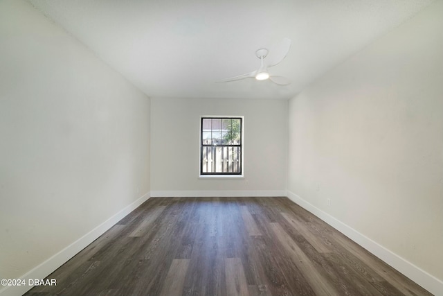 empty room with dark wood-type flooring and ceiling fan