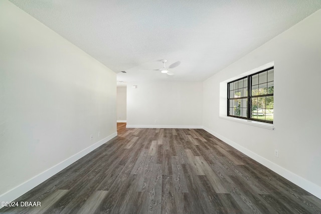 empty room featuring ceiling fan, dark hardwood / wood-style flooring, and a textured ceiling