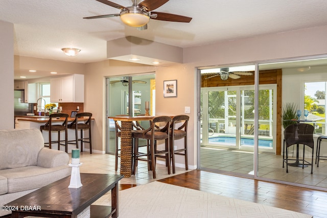 living room featuring a textured ceiling, light hardwood / wood-style floors, and sink