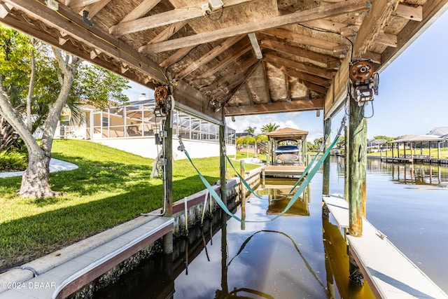 dock area with a water view and a yard