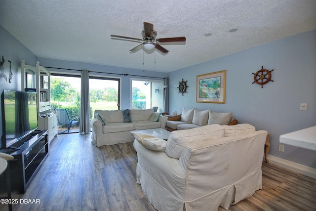 living room featuring a textured ceiling, hardwood / wood-style floors, and ceiling fan