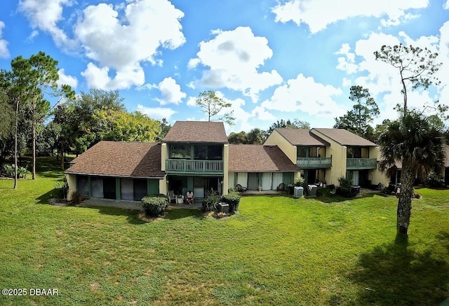 view of front of property with a sunroom and a front yard