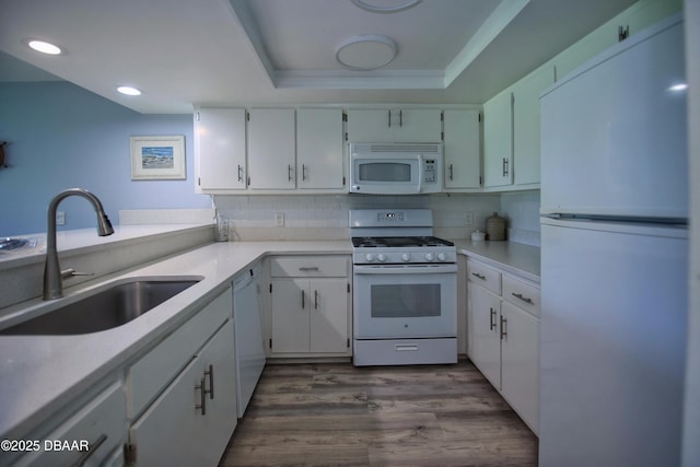 kitchen featuring white appliances, white cabinets, and sink