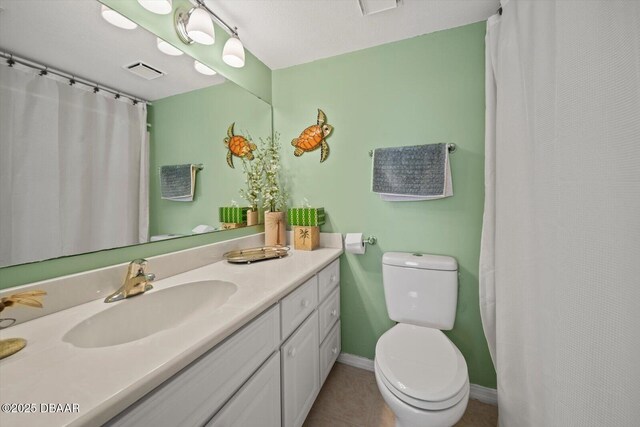 3100 Ocean Shore Blvd Unit 5020, Ormond Beach, FL 32176 - full bath with vanity, toilet, tile patterned flooring, baseboards, and a shower with shower curtain