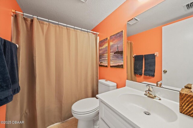 3100 Ocean Shore Blvd Unit 5020, Ormond Beach, FL 32176 - bathroom with toilet, vanity, a textured ceiling, tile patterned floors, and a shower with curtain