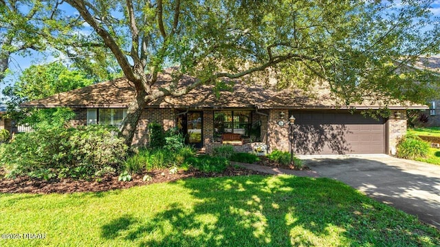 5 Southern Pine Trl, Ormond Beach, FL 32174 - view of front of property featuring brick siding, asphalt driveway, a front lawn, and a garage