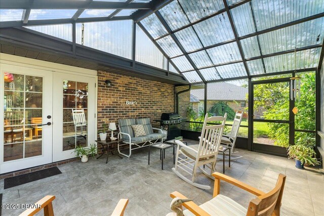 5 Southern Pine Trl, Ormond Beach, FL 32174 - sunroom with french doors, an outdoor living space, high vaulted ceiling, a wood stove, and brick wall
