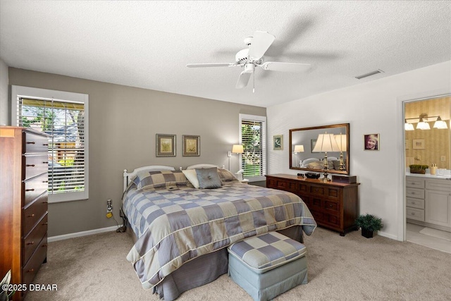 5 Southern Pine Trl, Ormond Beach, FL 32174 - bedroom featuring light carpet, a textured ceiling, a ceiling fan, and ensuite bathroom