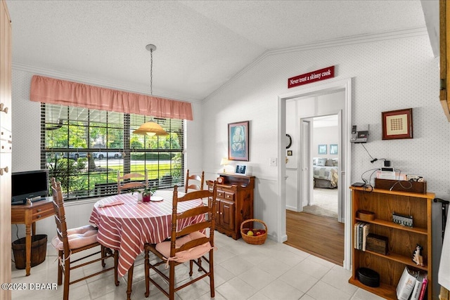 5 Southern Pine Trl, Ormond Beach, FL 32174 - dining area with vaulted ceiling, crown molding, light tile patterned floors, and a textured ceiling