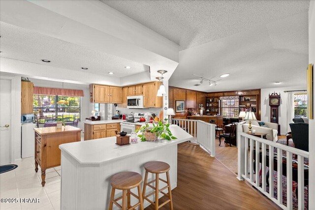 5 Southern Pine Trl, Ormond Beach, FL 32174 - kitchen featuring white appliances, a textured ceiling, light countertops, a ceiling fan, and open floor plan