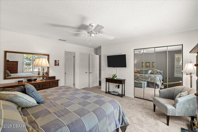 5 Southern Pine Trl, Ormond Beach, FL 32174 - bedroom with light colored carpet, a textured ceiling, a ceiling fan, and a closet