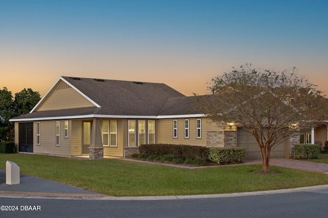 view of front of house featuring a lawn and a garage