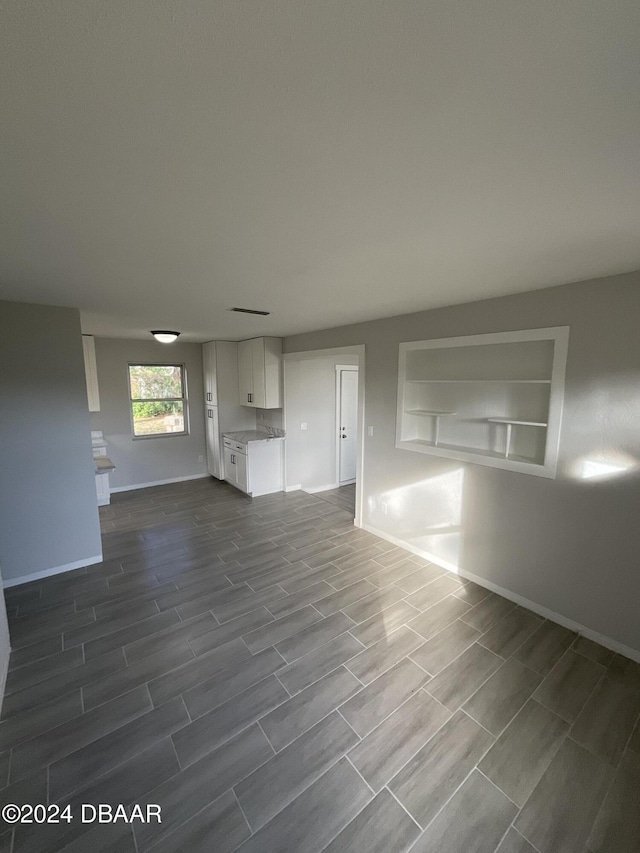 unfurnished living room featuring hardwood / wood-style floors