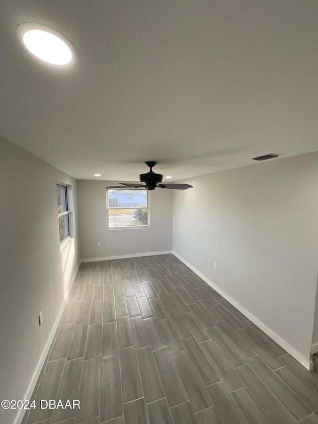 spare room featuring ceiling fan and dark hardwood / wood-style flooring